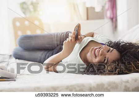 Portrait of teenage girl (16-17) texting in bedroom View Large Photo Image Stock Photography - Portrait of teenage girl (16-17) texting in bedroom. Fotosearch