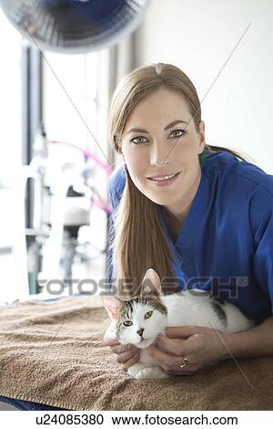 Stock Image - Portrait of vet with cat. Fotosearch