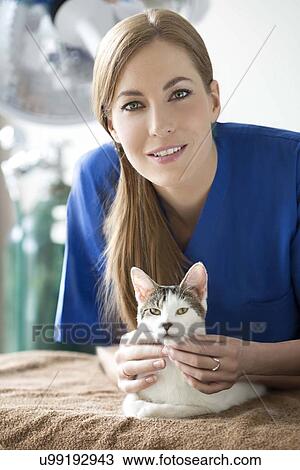 Stock Image - Portrait of vet with cat. Fotosearch