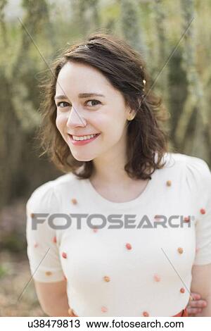 Stock Image - Portrait of young smiling woman. Fotosearch