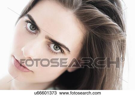 Stock Image - Portrait of young woman in studio. Fotosearch
