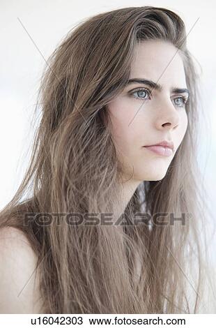 Stock Image - Portrait of young woman with blue eyes. Fotosearch