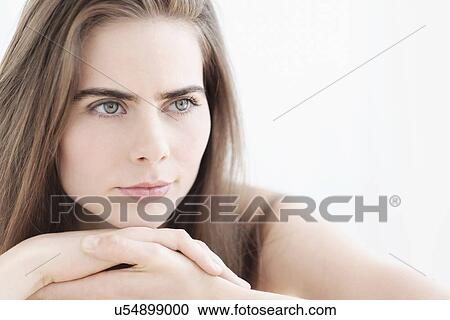 Stock Image - Portrait of young woman with blue eyes. Fotosearch