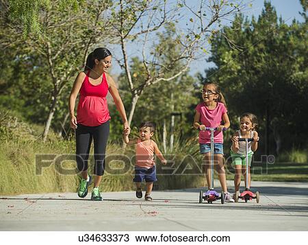 Pregnant mother and children (2-3, 6-7, 8-9) walking outdoors View Large Photo Image Stock Image - Pregnant mother and children (2-3, 6-7, 8-9) walking outdoors. Fotosearch