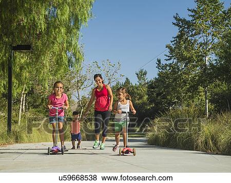 Pregnant mother and children (2-3, 6-7, 8-9) walking outdoors View Large Photo Image Stock Photo - Pregnant mother and children (2-3, 6-7, 8-9) walking outdoors. Fotosearch
