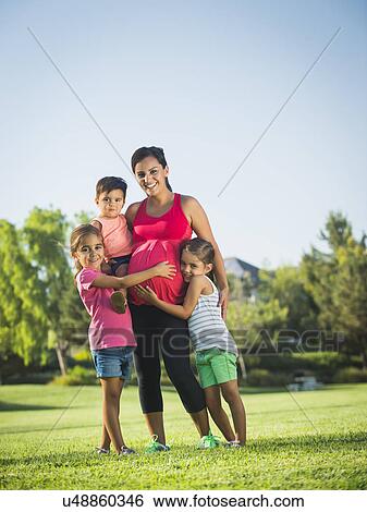 Pregnant mother and children (2-3, 6-7, 8-9) in park View Large Photo Image Stock Photograph - Pregnant mother and children (2-3, 6-7, 8-9) in park. Fotosearch