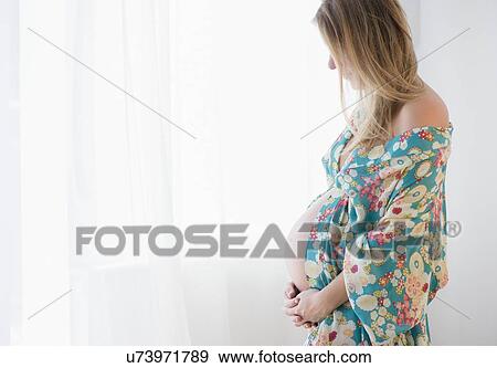 Pregnant woman in colorful dressing gown View Large Photo Image Stock Photo - Pregnant woman in colorful dressing gown. Fotosearch