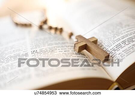 Stock Image - Rosary beads in open Bible. Fotosearch