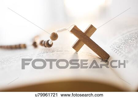Stock Image - Rosary beads in open Bible. Fotosearch
