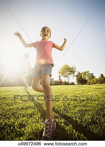 Stock Photograph - Siblings (2-3, 6-7, 8-9) playing in park. Fotosearch