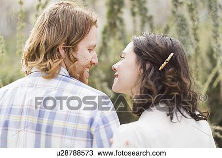 Smiling couple looking at each other View Large Photo Image Stock Image - Smiling couple looking at each other. Fotosearch