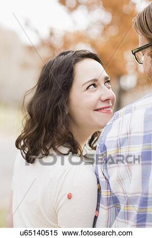 Stock Photography - Smiling couple looking at each other. Fotosearch