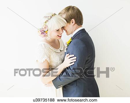 Stock Photo - Smiling newlywed couple embracing. Fotosearch