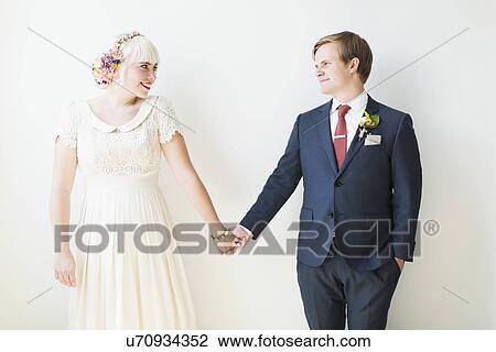 Stock Image - Smiling newlywed couple in studio. Fotosearch