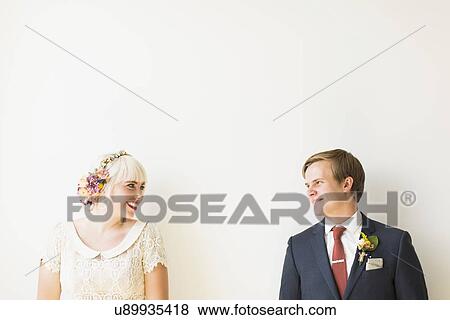 Stock Photo - Smiling newlywed couple in studio. Fotosearch