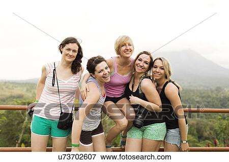 Stock Photo - Smiling women by railing. Fotosearch