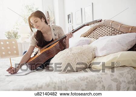 Teenage girl (14-15) playing guitar View Large Photo Image Stock Image - Teenage girl (14-15) playing guitar. Fotosearch