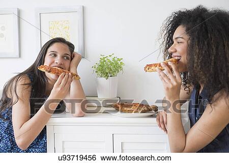 Teenage girls (14-15, 16-17) eating pizza View Large Photo Image Stock Photograph - Teenage girls (14-15, 16-17) eating pizza. Fotosearch