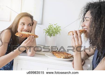 Teenage girls (14-15, 16-17) eating pizza View Large Photo Image Stock Photography - Teenage girls (14-15, 16-17) eating pizza. Fotosearch