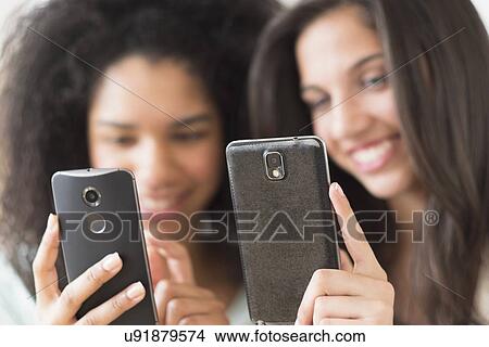 Teenage girls (14-15, 16-17) using smart phones View Large Photo Image Picture - Teenage girls (14-15, 16-17) using smart phones. Fotosearch