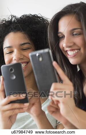 Teenage girls (14-15, 16-17) using smart phones View Large Photo Image Stock Photo - Teenage girls (14-15, 16-17) using smart phones. Fotosearch