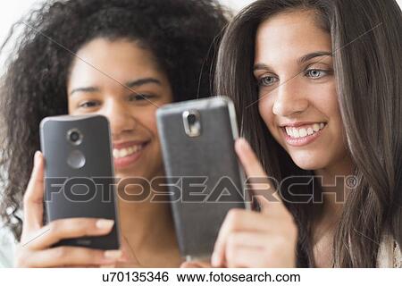 Teenage girls (14-15, 16-17) using smart phones View Large Photo Image Stock Photograph - Teenage girls (14-15, 16-17) using smart phones. Fotosearch