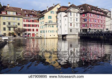 Stock Photography - Townhouses reflecting in water. Fotosearch
