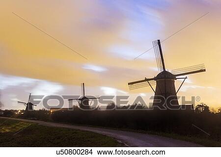Picture - Traditional windmills at sunset. Fotosearch