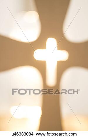 Picture - View of backlit cross. Fotosearch