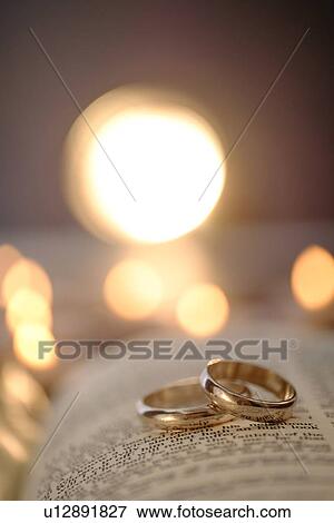 Stock Photo - Wedding rings in open Bible. Fotosearch