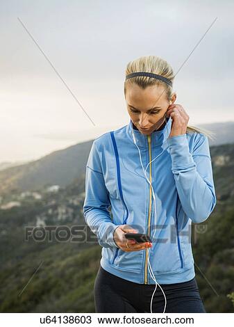 Woman checking smart phone View Large Photo Image Stock Image - Woman checking smart phone. Fotosearch
