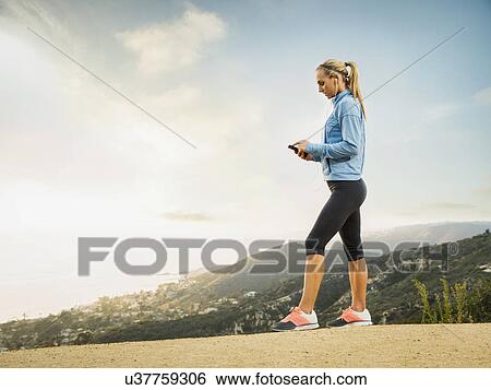 Woman checking smart phone View Large Photo Image Stock Photograph - Woman checking smart phone. Fotosearch