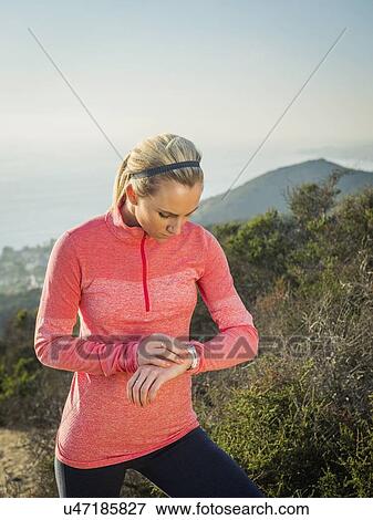 Stock Photo - Woman checking watch. Fotosearch