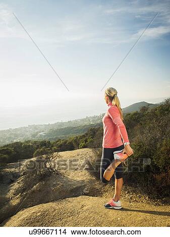 Woman exercising in mountains View Large Photo Image Picture - Woman exercising in mountains. Fotosearch