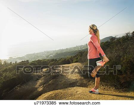 Woman exercising in mountains View Large Photo Image Stock Photography - Woman exercising in mountains. Fotosearch