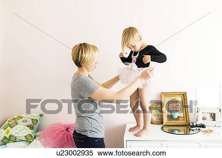 Woman helping daughter (4-5) with costume View Large Photo Image Stock Photography - Woman helping daughter (4-5) with costume. Fotosearch