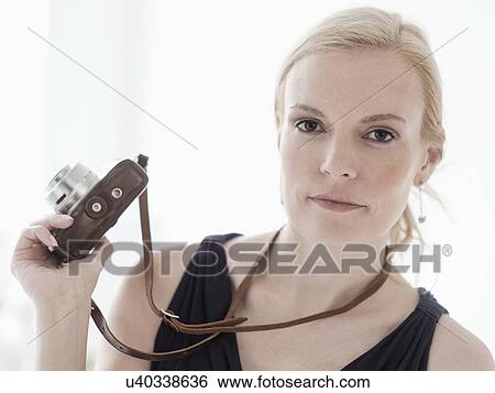 Woman holding digital camera View Large Photo Image Stock Photograph - Woman holding digital camera. Fotosearch