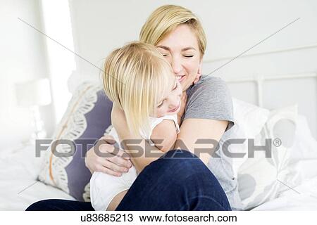 Woman hugging daughter (2-3) in bedroom View Large Photo Image Stock Image - Woman hugging daughter (2-3) in bedroom. Fotosearch