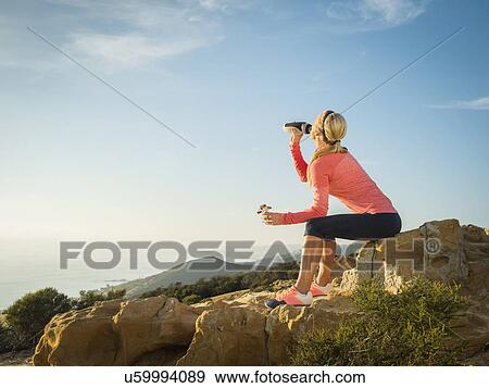 Woman in sportswear drinking water View Large Photo Image Stock Photo - Woman in sportswear drinking water. Fotosearch