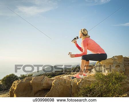 Woman in sportswear drinking water View Large Photo Image Stock Photo - Woman in sportswear drinking water. Fotosearch