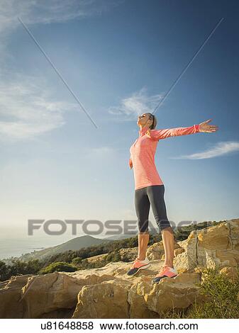 Woman in sportswear with outstretched arms View Large Photo Image Stock Photo - Woman in sportswear with outstretched arms. Fotosearch