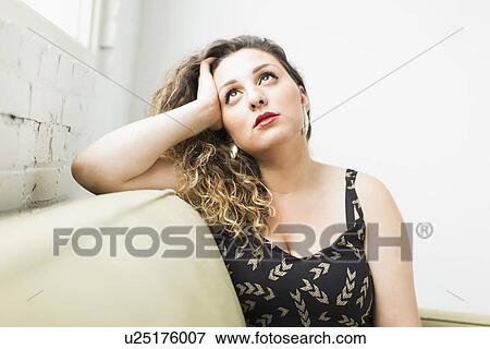 Woman looking up and daydreaming View Large Photo Image Stock Photo - Woman looking up and daydreaming. Fotosearch