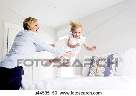 Woman playing with girl (2-3) in bedroom View Large Photo Image Stock Image - Woman playing with girl (2-3) in bedroom. Fotosearch