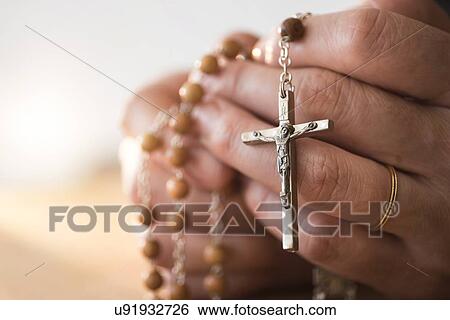 Woman praying with rosary beads in hands View Large Photo Image Stock Photograph - Woman praying with rosary beads in hands. Fotosearch