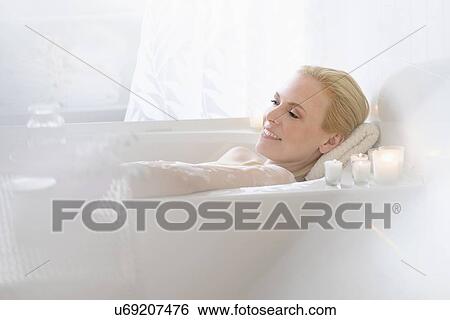 Woman relaxing in bath View Large Photo Image Stock Photograph - Woman relaxing in bath. Fotosearch