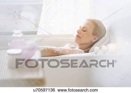 Stock Photograph - Woman relaxing in bath. Fotosearch