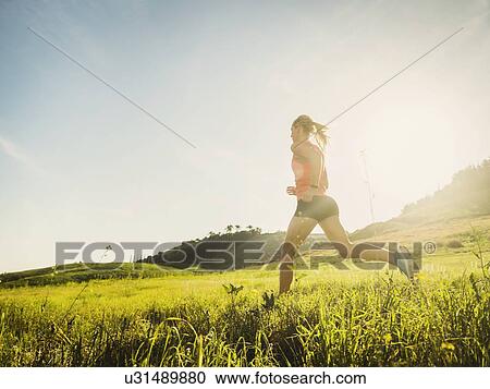 Woman running in field View Large Photo Image Stock Image - Woman running in field. Fotosearch