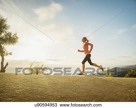 Woman running in mountains View Large Photo Image Stock Image - Woman running in mountains. Fotosearch