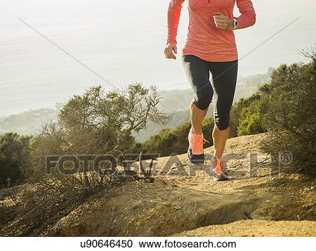 Woman running in mountains View Large Photo Image Stock Image - Woman running in mountains. Fotosearch