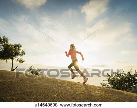 Woman running in mountains View Large Photo Image Stock Photo - Woman running in mountains. Fotosearch